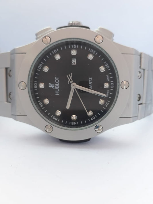 Hublot watch with black dial and silver case on a white background