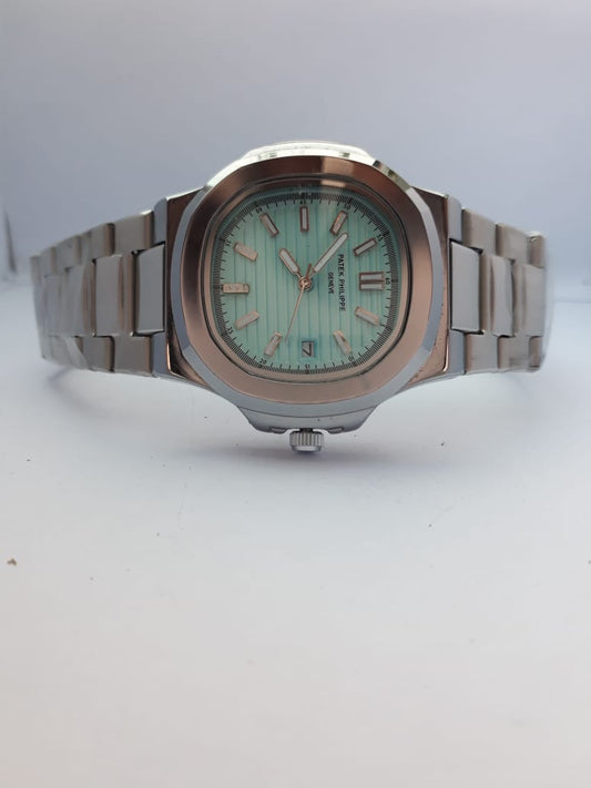 Silver watch with a light green face on a white background