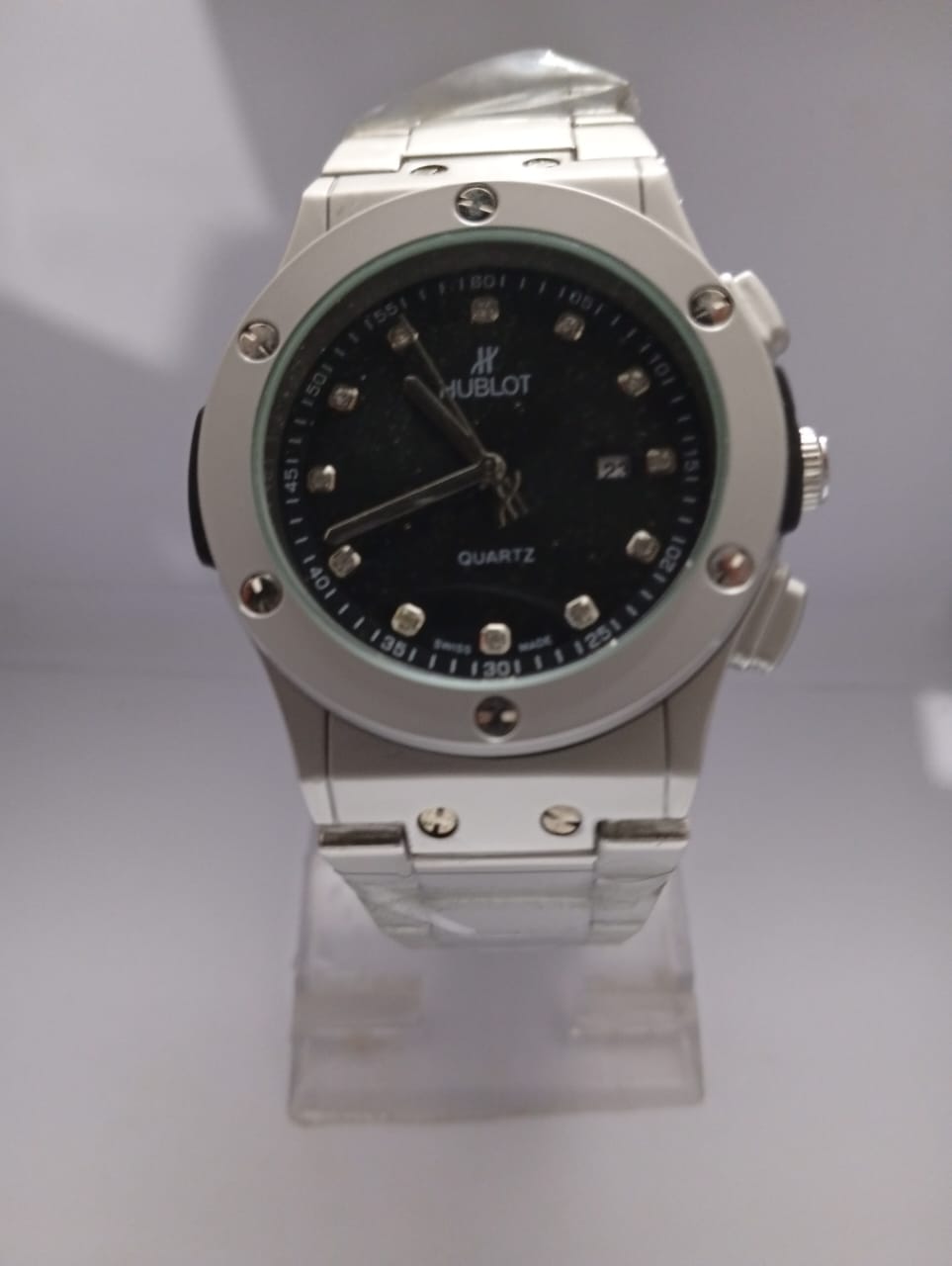 Hublot watch on a stand with a white background