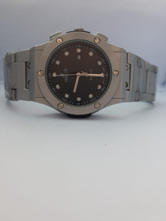 Silver watch with a black face on a light gray background