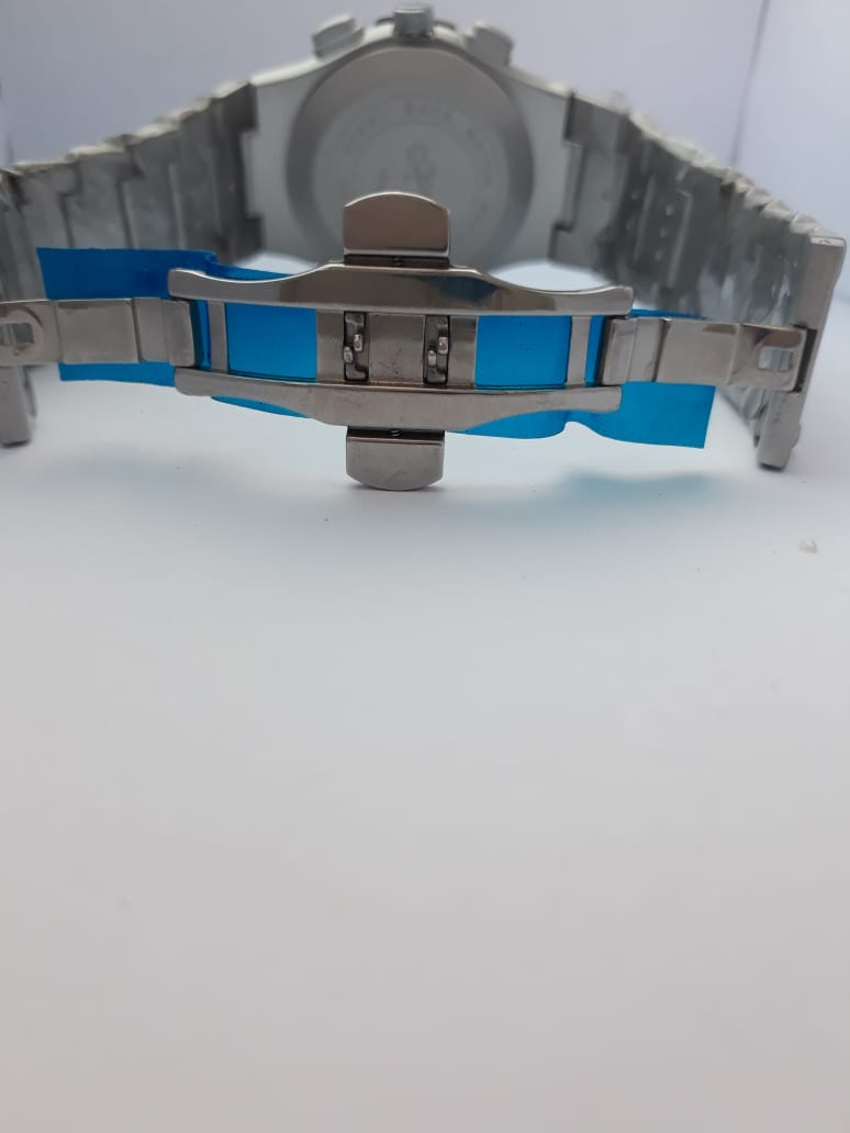 Close-up of a watch with a blue and silver band on a white background