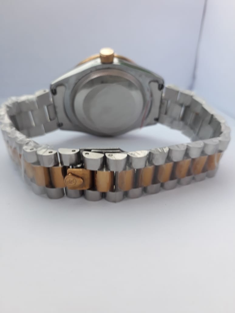 Silver watch with a brown steel strap on a white background
