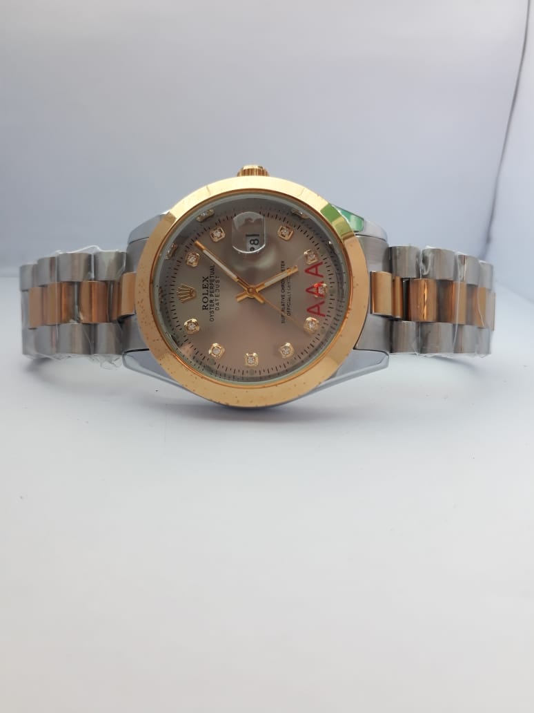 Two-tone watch with gold and silver band on a light gray background