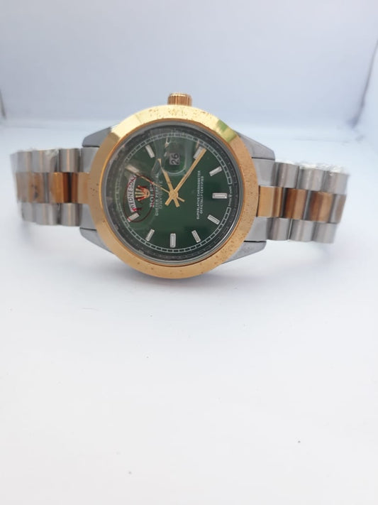 Two-tone watch with green dial on a white background