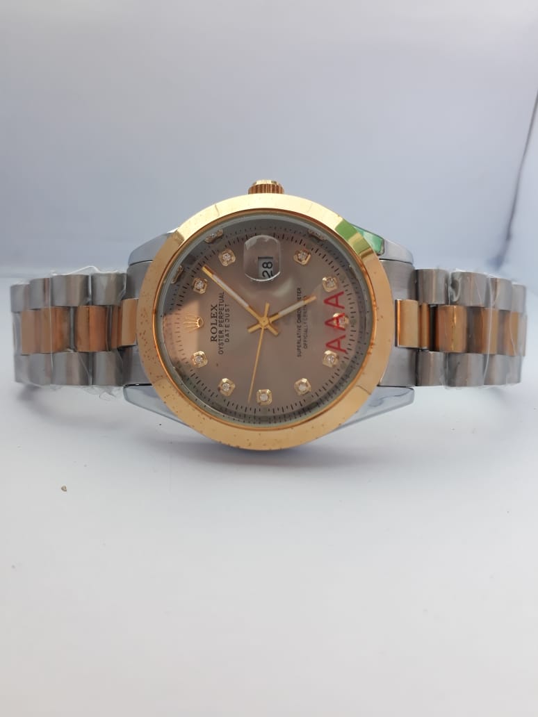 Two-tone watch with gold and silver band on a white background