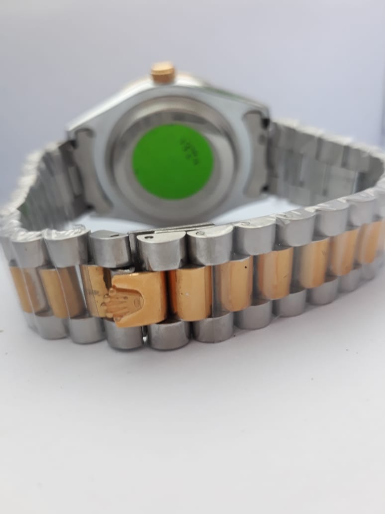 Metallic watch band with a visible brand logo on a white background